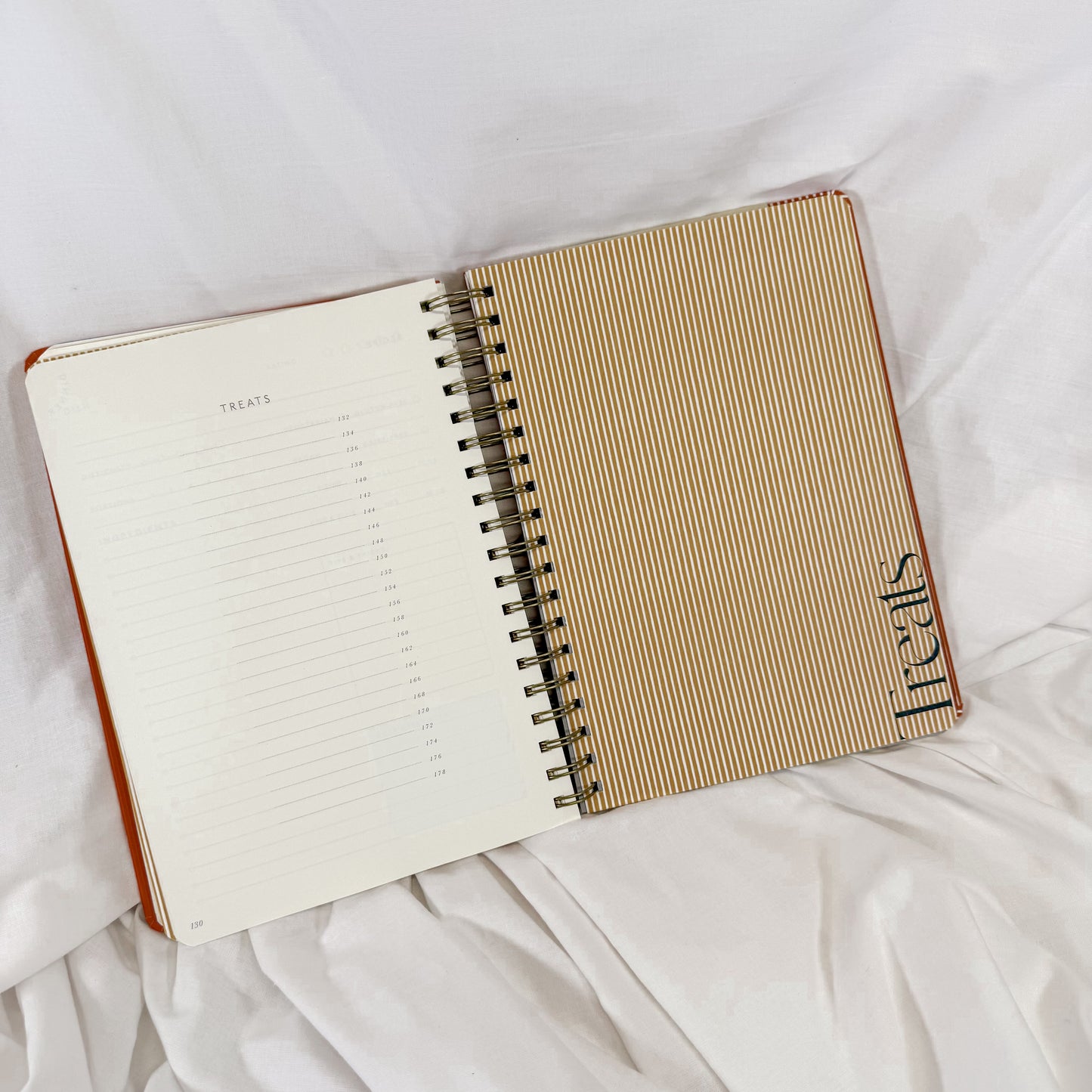 Open notebook with spiral binding on a white surface