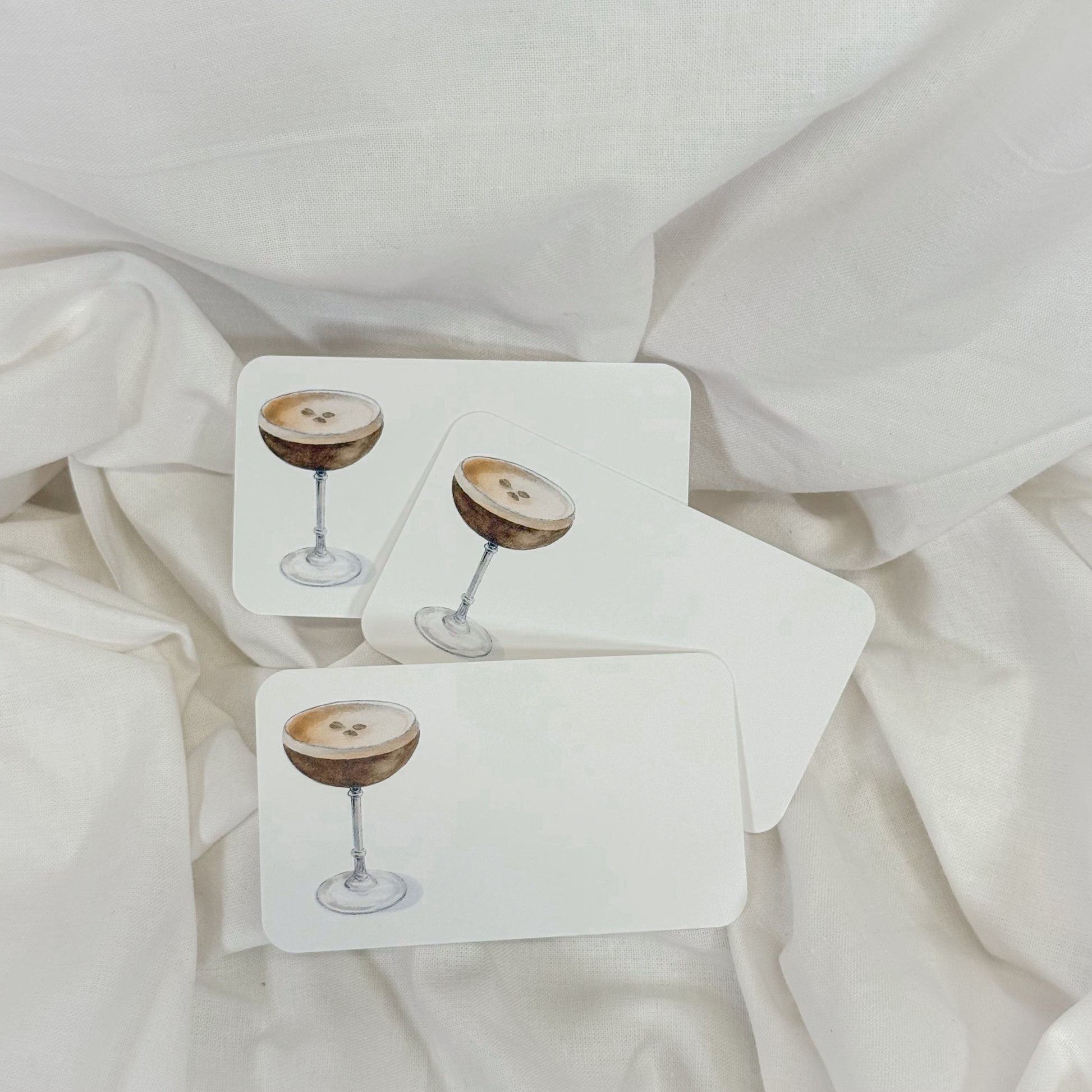 Espresso martini mini notecards on a white fabric background