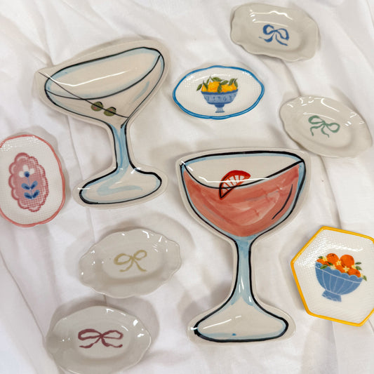 Girly jewelry dishes on a white fabric background